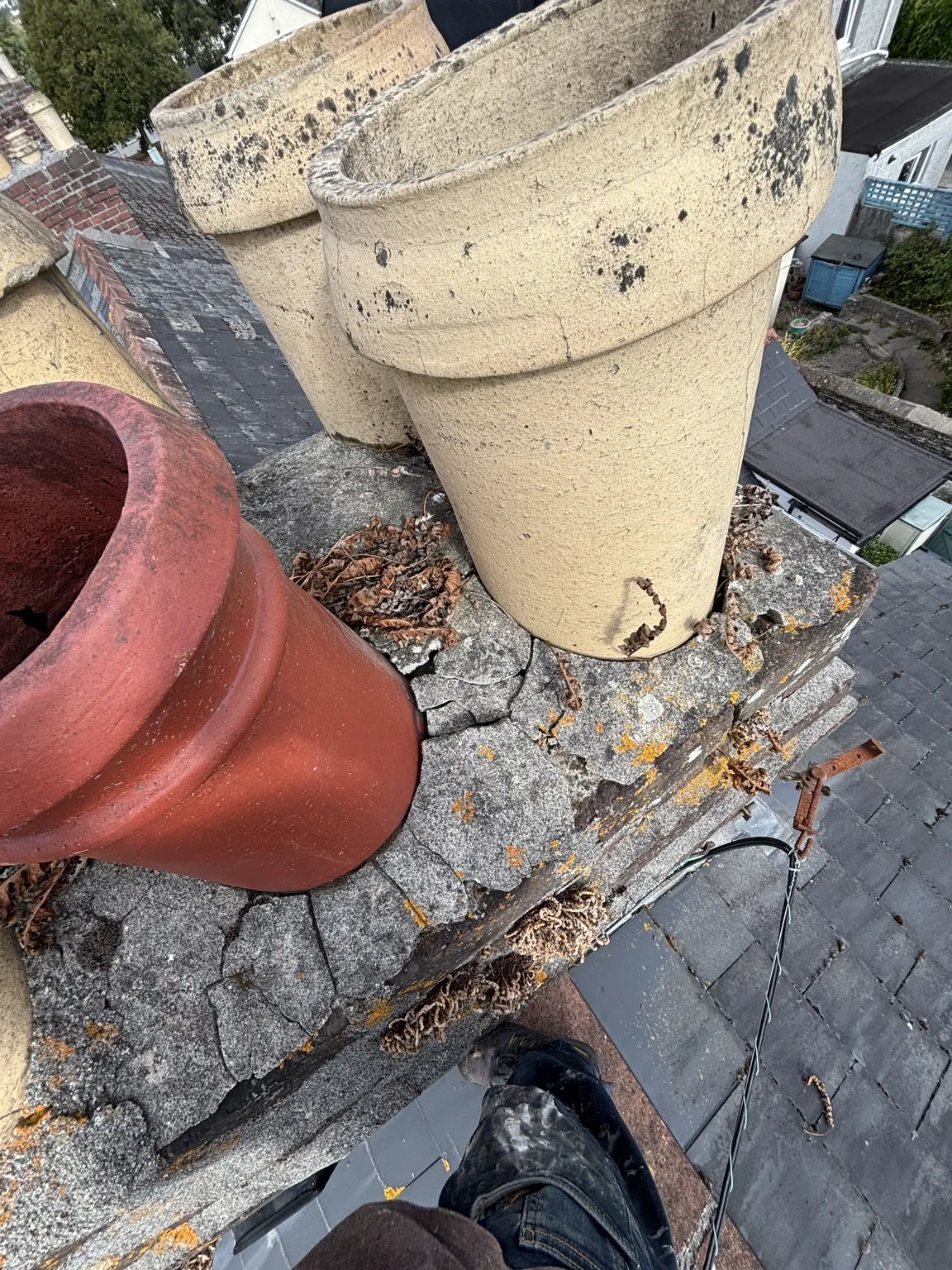 Deteriorated chimney flaunching before repair by Shield Roofing