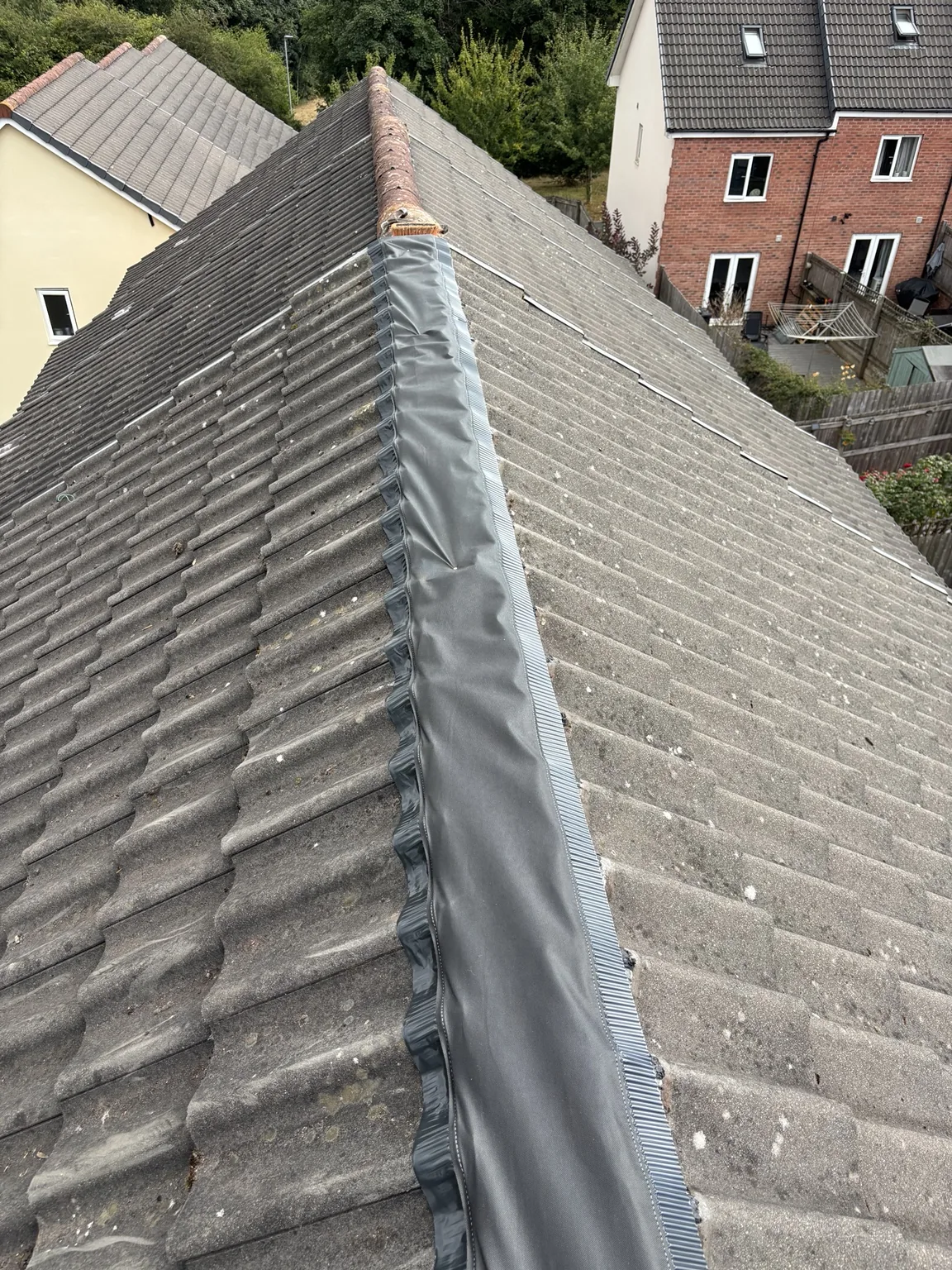 Dry ridge roll installed on a pitched roof by Shield Roofing